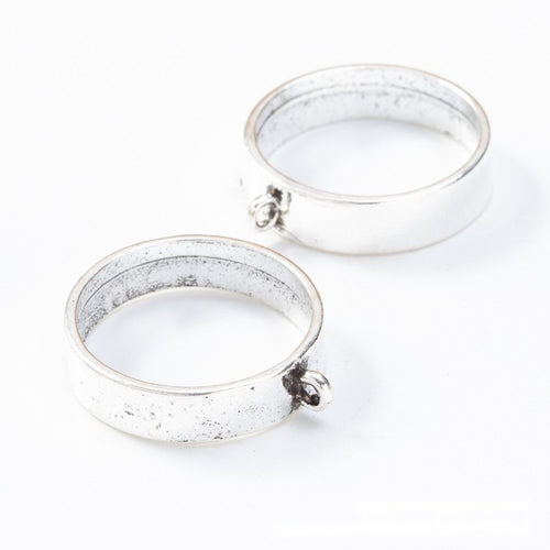 Close-up view of the round open back bezel pendant frames in two finishes showing its front and reverse metal details.