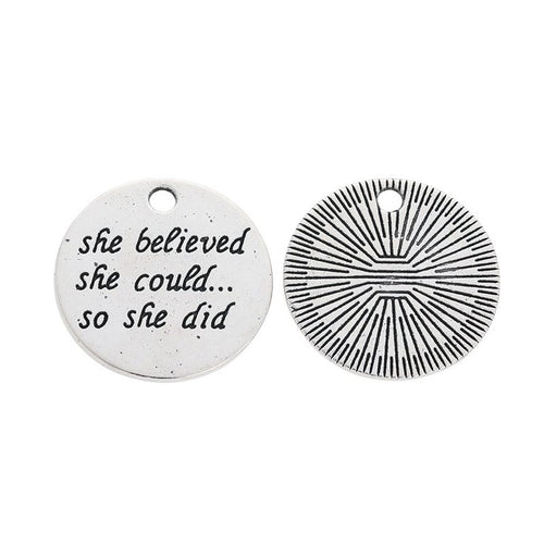 Front detail of she believed she could round metal charm