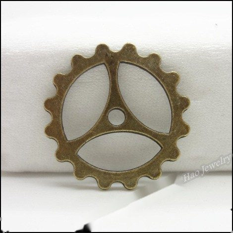 Close view showing the front details of the three-spoke gear charms