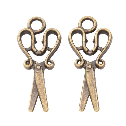 Close-up view of the scissors metal charms in four metallic finishes showing its front and reverse metal details.