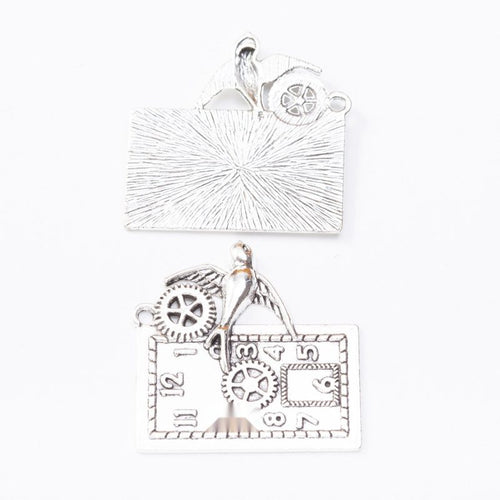 Front and reverse view of the clock gear charm