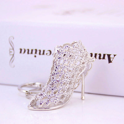 Silver-tone openwork high heel keychain shown from the front.