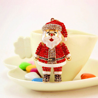 Front view of the rhinestone Santa figure displayed in front of a cup and saucer.