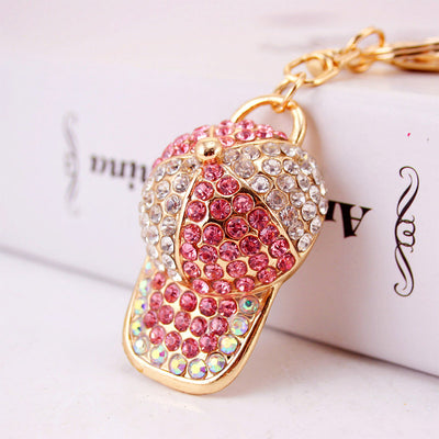 Close-up of a pink and clear rhinestone baseball cap keychain
