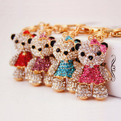 Four rhinestone bear keychains shown together in red, purple, blue, and pink dresses.