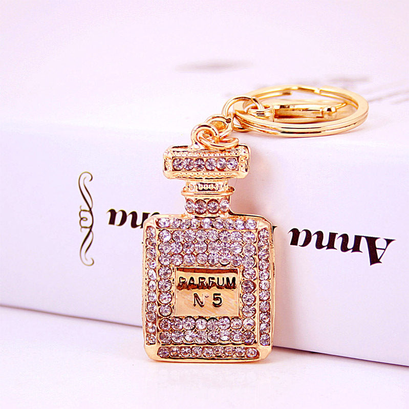 Rhinestone Perfume Bottle Keychain with Four Leaf Clover Metal Bag Charm