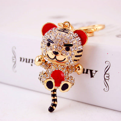 Close view of a clear rhinestone tiger keychain with red ears and belly.