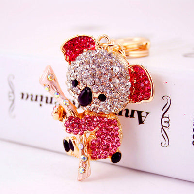 Close-up of a pink rhinestone koala holding a pale pink branch.