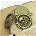 Skull and Crossbones Round Medallion Charm in Antique Bronze view 3