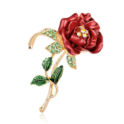 Front product view of the rose brooch pin in red and gold
