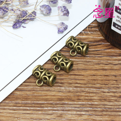 Closer view of the open scroll large-hole spacer bead surface and openwork details