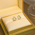 Elegant French Gold Alloy Huggie Hoop With Oval Zircon Crystal Charm Light Luxury Stud Earrings view 2