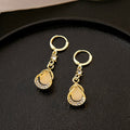 Elegant Gold Alloy Teardrop Huggie Earrings With Micro Pave Rhinestone Cat Eye Crystal Hollow Drop Earrings view 3