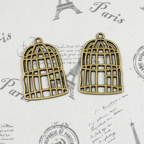 Alternate view of the openwork birdcage charm showing its raised and recessed details