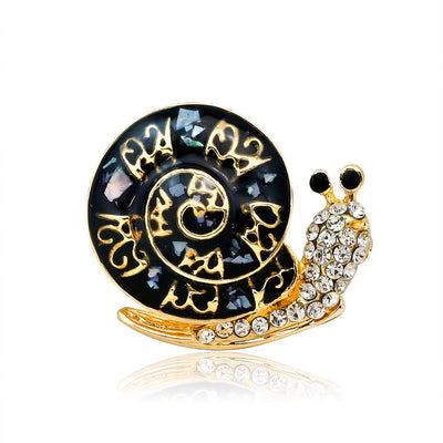 Front product view of the snail brooch pin in gold and black