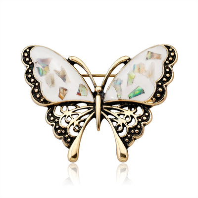 Front product view of the butterfly brooch pin in gold and black