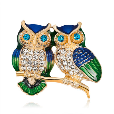 Front product view of the owl brooch pin in gold and green