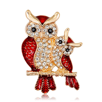 Front product view of the owl brooch pin in gold and red