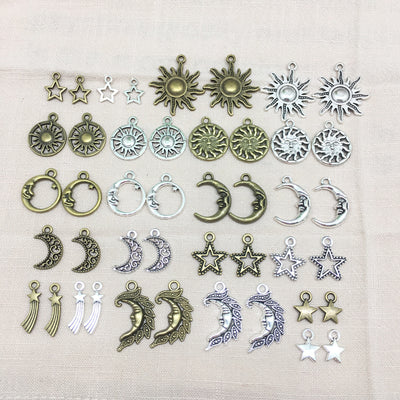 Metallic moon and sun charms arranged on a light background