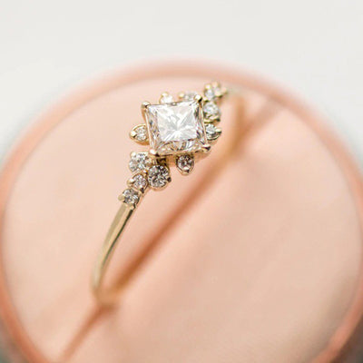 Gold-tone square clear solitaire ring with leaf side accents