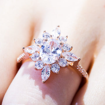 Rose Gold Tone Oval Halo Ring With Peach Center Stone