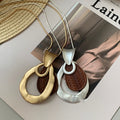 Light Luxury Wood Hollow Teardrop Pendant Sweater Necklace With Geometric Wrinkle Design view 3
