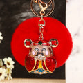 Jeweled Wealth Figure Keychains with Faux Fur Poms in Four Pictured Colors view 1
