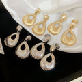 Light Luxury Zinc Alloy Teardrop Textured Hollow Pendant Clip-on Earrings view 3