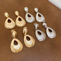 Light Luxury Zinc Alloy Teardrop Textured Hollow Pendant Clip-on Earrings view 1
