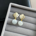 Elegant White Cat Eye Stone Pearl Drop With Rhinestone Inlaid Gold Alloy Enamel Shell Stud Earrings view 4