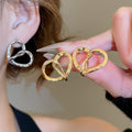 18K Gold Plated Metal Heart Earrings With Silver Pins, Twisted Hollow Minimalist Stud Design view 1