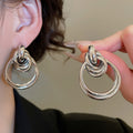 European Style Glossy Iron Knot Round Pendant Drop Earrings With Silver Tone Posts view 4