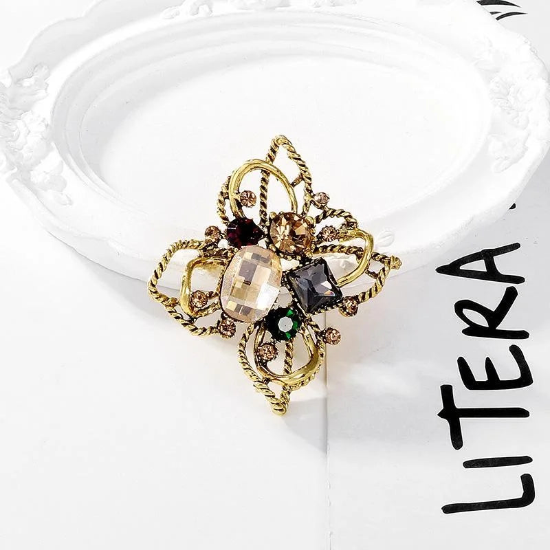 Vintage Baroque Floral Alloy Rhinestone Brooch With Twisted Gold Tone Petals, Elegant Lapel Pin Gift