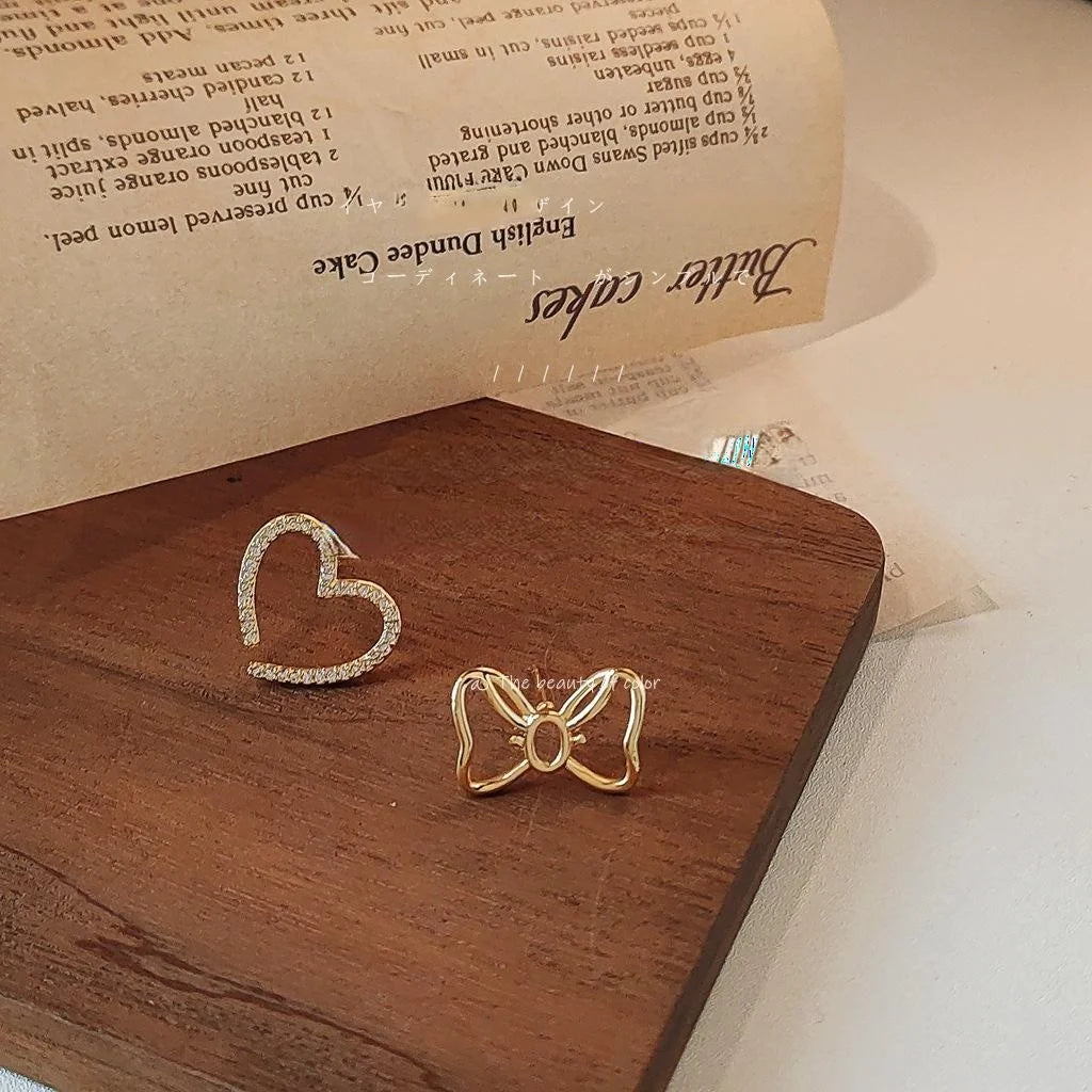 Sweet Copper Asymmetric Bow Heart Stud Earrings With Hollow Micro Pave Zircon