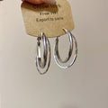 Polished Double Hoop Earrings In Gold And Three Silver Sizes view 9