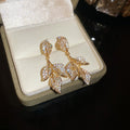 Crystal Leaf Branch Drop Earrings in Gold and Silver Tones view 6