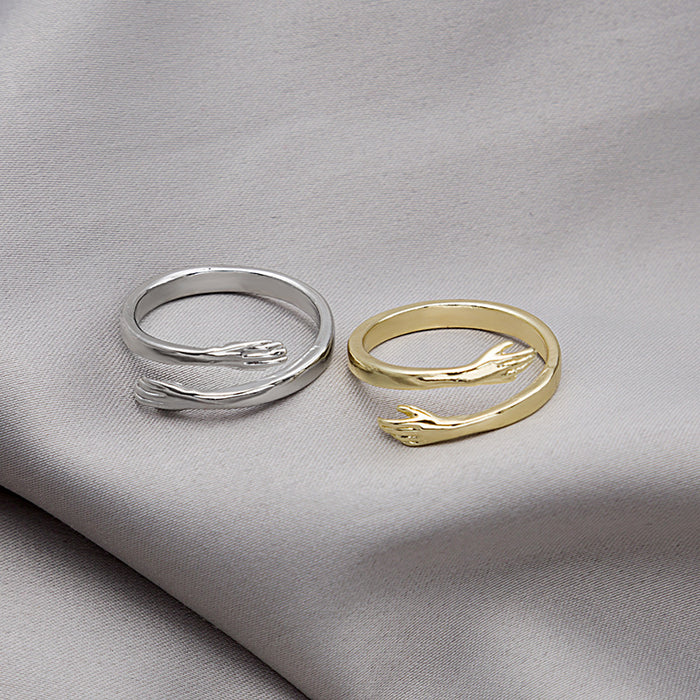 Embracing Hands Adjustable Open Band Rings in Four Finishes
