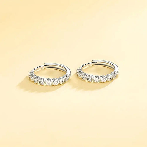 Pair of small stone hoops on soft yellow background