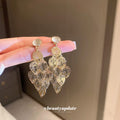 Gold Tone Filigree Leaf Cluster Drop Earrings With Polished Metal Tone Details view 1