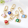 Gold Tone Openwork Lash Enamel Evil Eye Clip Keychains in Five Colors view 1
