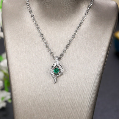 Silver wave green CZ pendant necklace on gray fabric jewelry bust