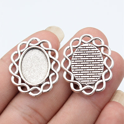 Wavy Edge Oval Pendant Setting 13x18mm in Two Finishes shown in hand