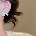 White Bow Stud Earrings With Gold Tone Speckled Detail view 3