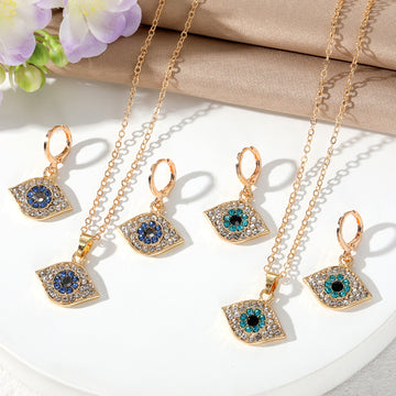 Gold Tone Crystal Evil Eye Necklace and Huggie Earring Options