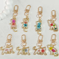 Gold Tone Pressed Flower Cat Resin Clip Keychains in Eight Designs view 1