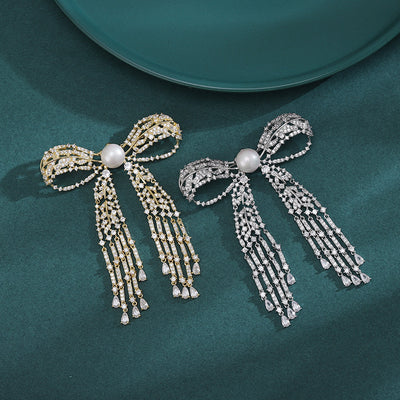Gold and silver pearl center bow brooches with crystal tassels
