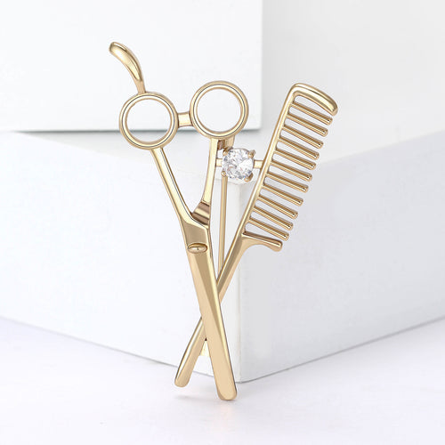 The second image presents an alternate display of the scissors and comb brooch.