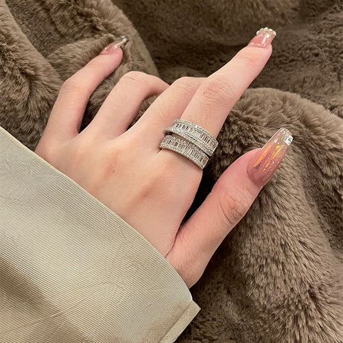 Silver baguette CZ open ring worn on index finger