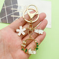 Cat Charm Keychains Featuring White Flower Across 19 Pictured Variations view 1