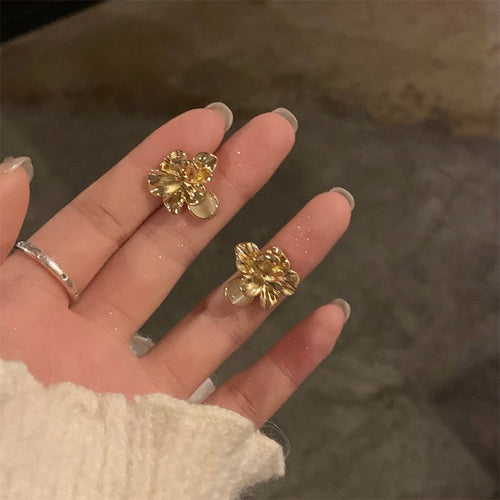 gold tone textured petal floral cluster stud earrings displayed from a second angle